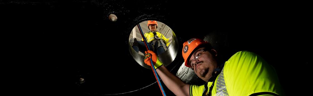 man descending into a confined space