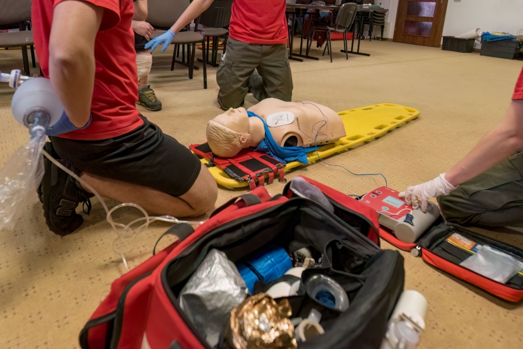 Closeup of medical professionals performing CPR on a mannequin on the floor