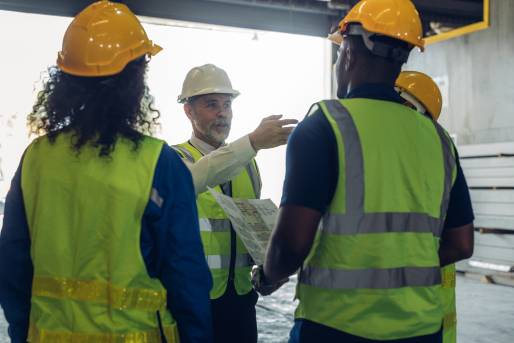 onstruction crew reviewing a fire prevention checklist during a daily jobsite safety meeting.