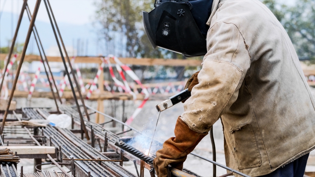 Construction worker following hot work safety procedures to reduce fire hazards on the jobsite